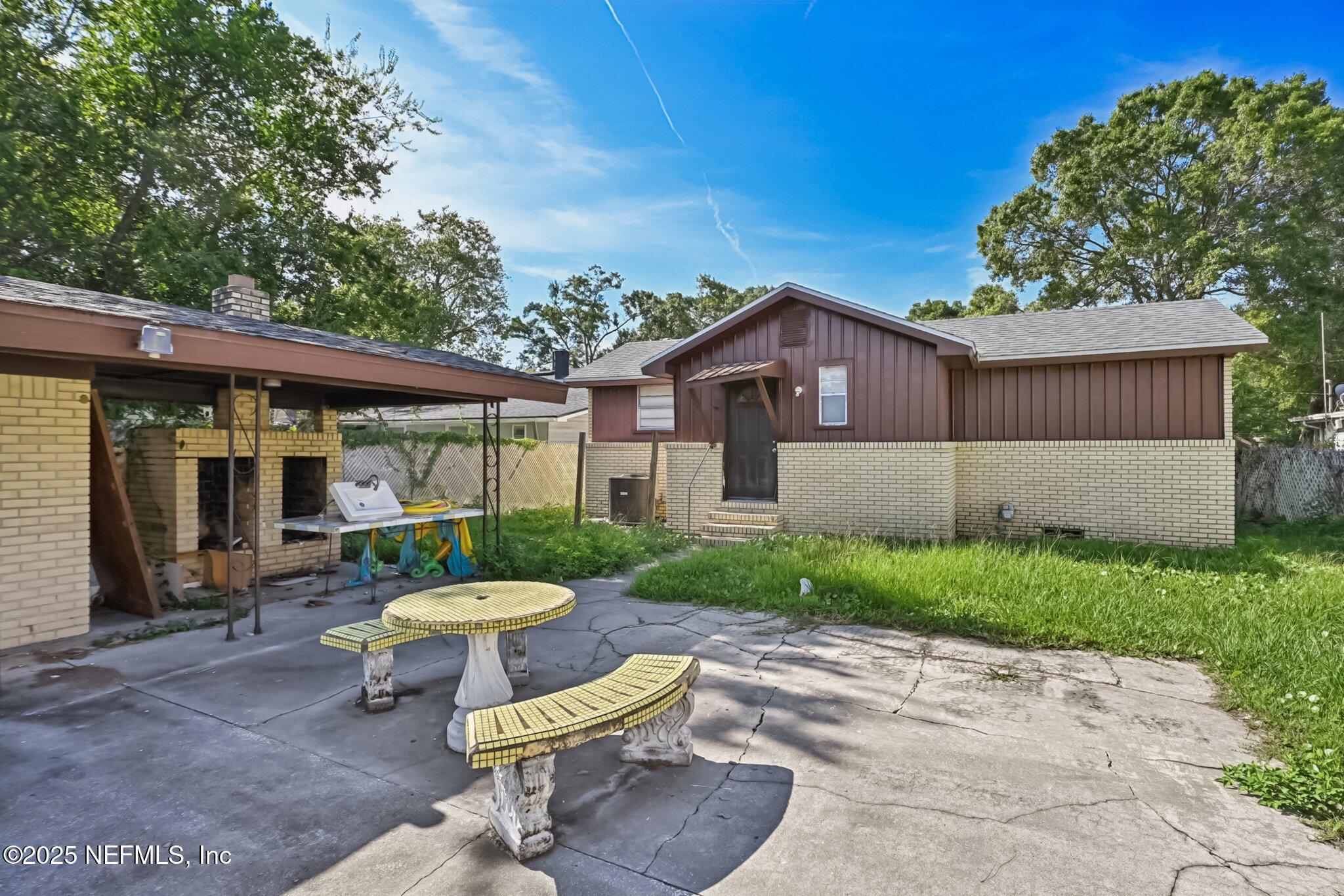5635 Atlee Avenue Jacksonville, FL 32205 - Photo 25 of 31 a view of a chair and table in backyard of the house