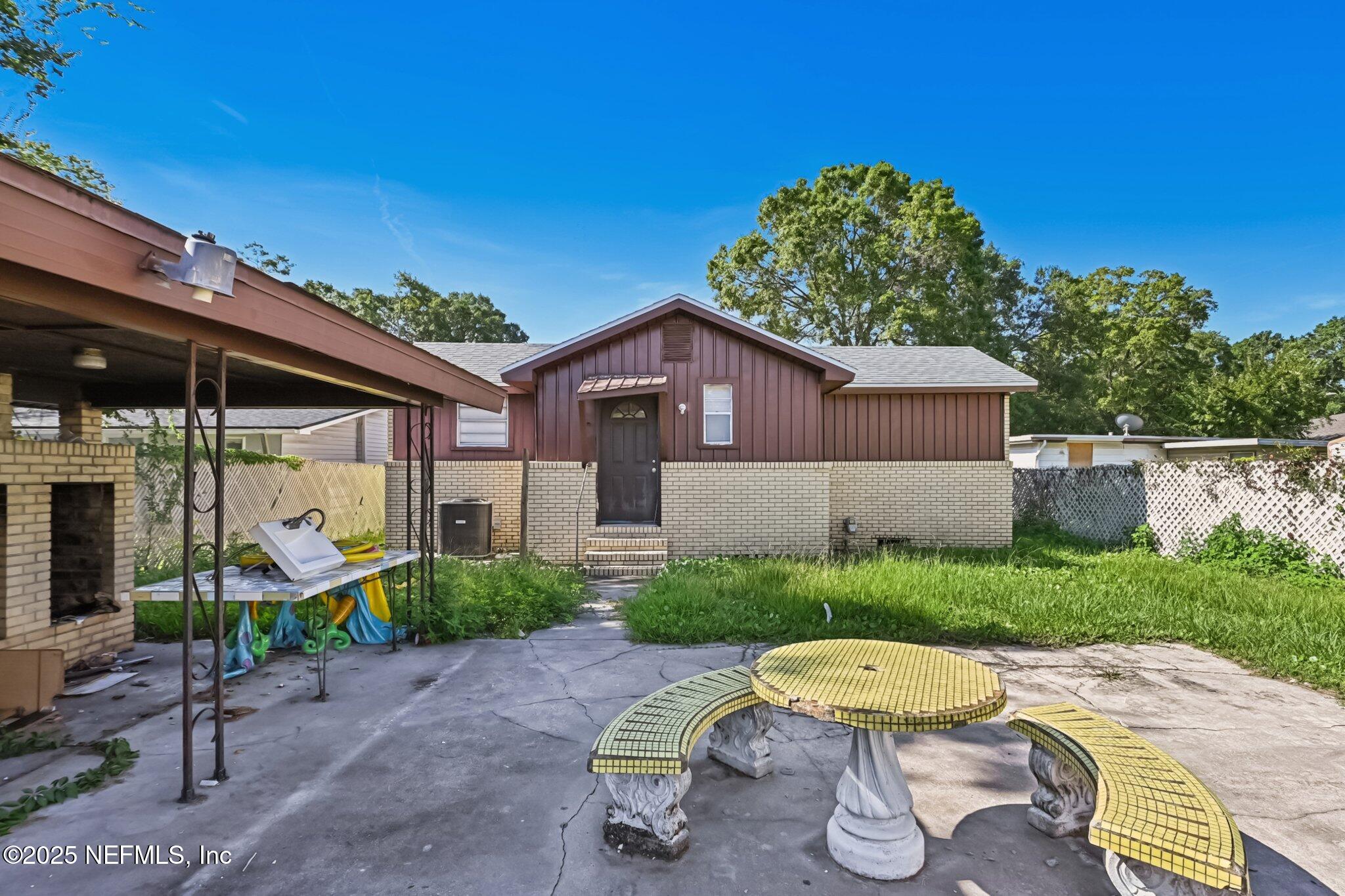 5635 Atlee Avenue Jacksonville, FL 32205 - Photo 28 of 31 a view of a chair and table in backyard of the house