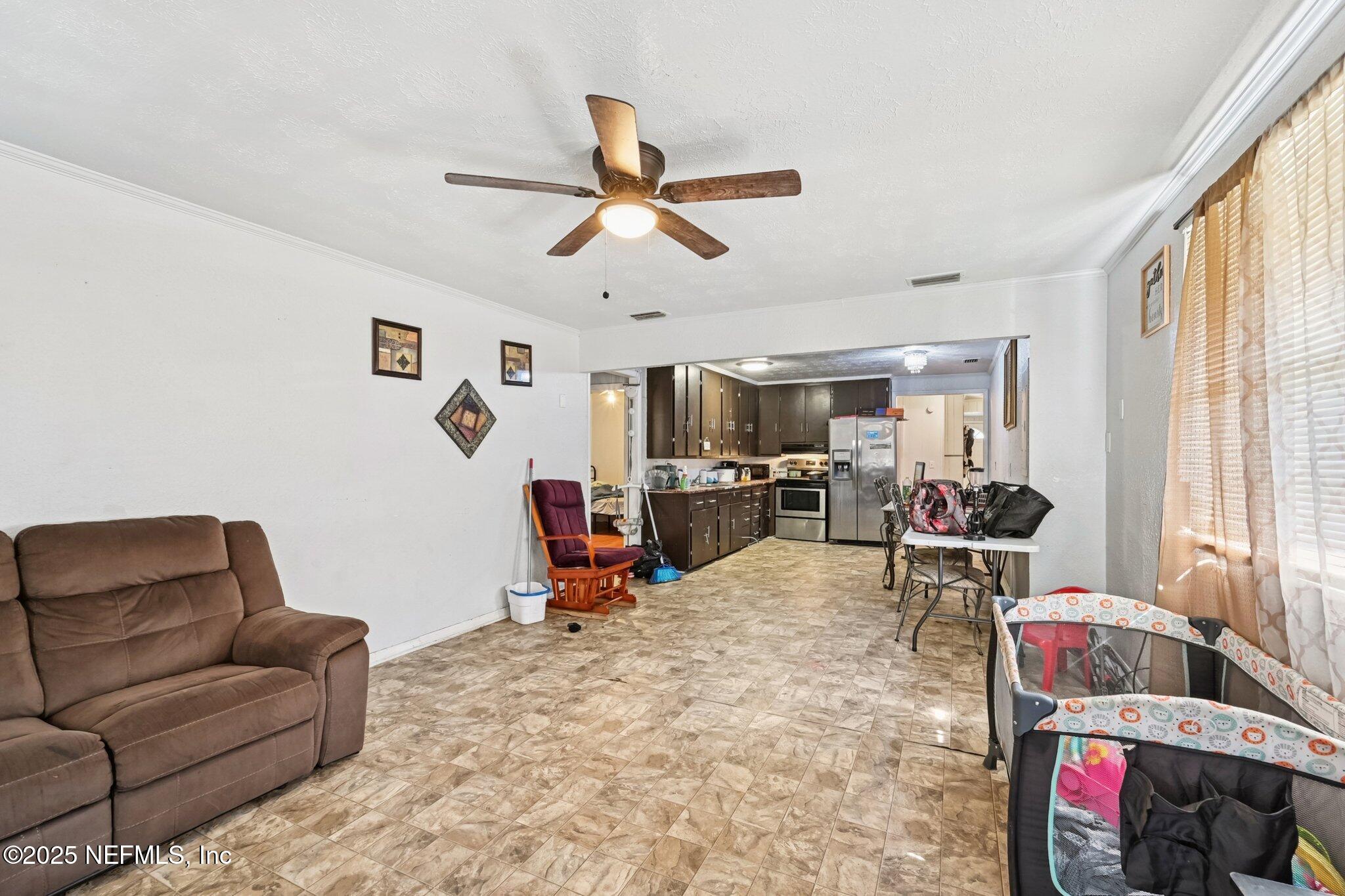 5635 Atlee Avenue Jacksonville, FL 32205 - Photo 8 of 31 a living room with furniture and a flat screen tv