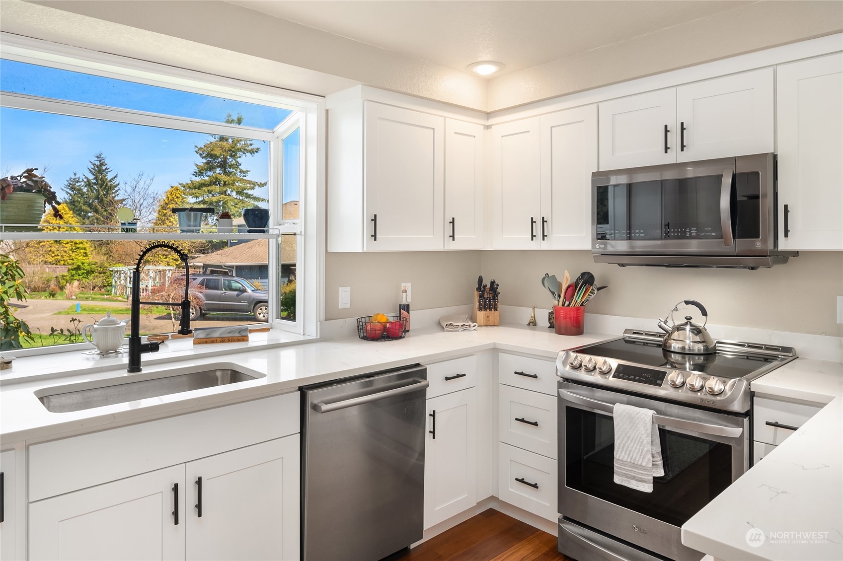 23530 22nd Avenue Southeast Bothell, WA 98021 - Photo 12 of 30 a kitchen with stainless steel appliances granite countertop a sink and a stove