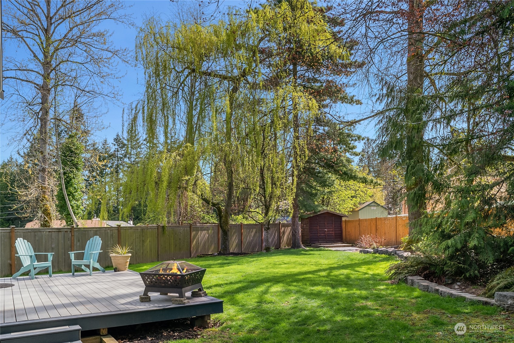 23530 22nd Avenue Southeast Bothell, WA 98021 - Photo 26 of 30 a view of a backyard with table and chairs and wooden fence