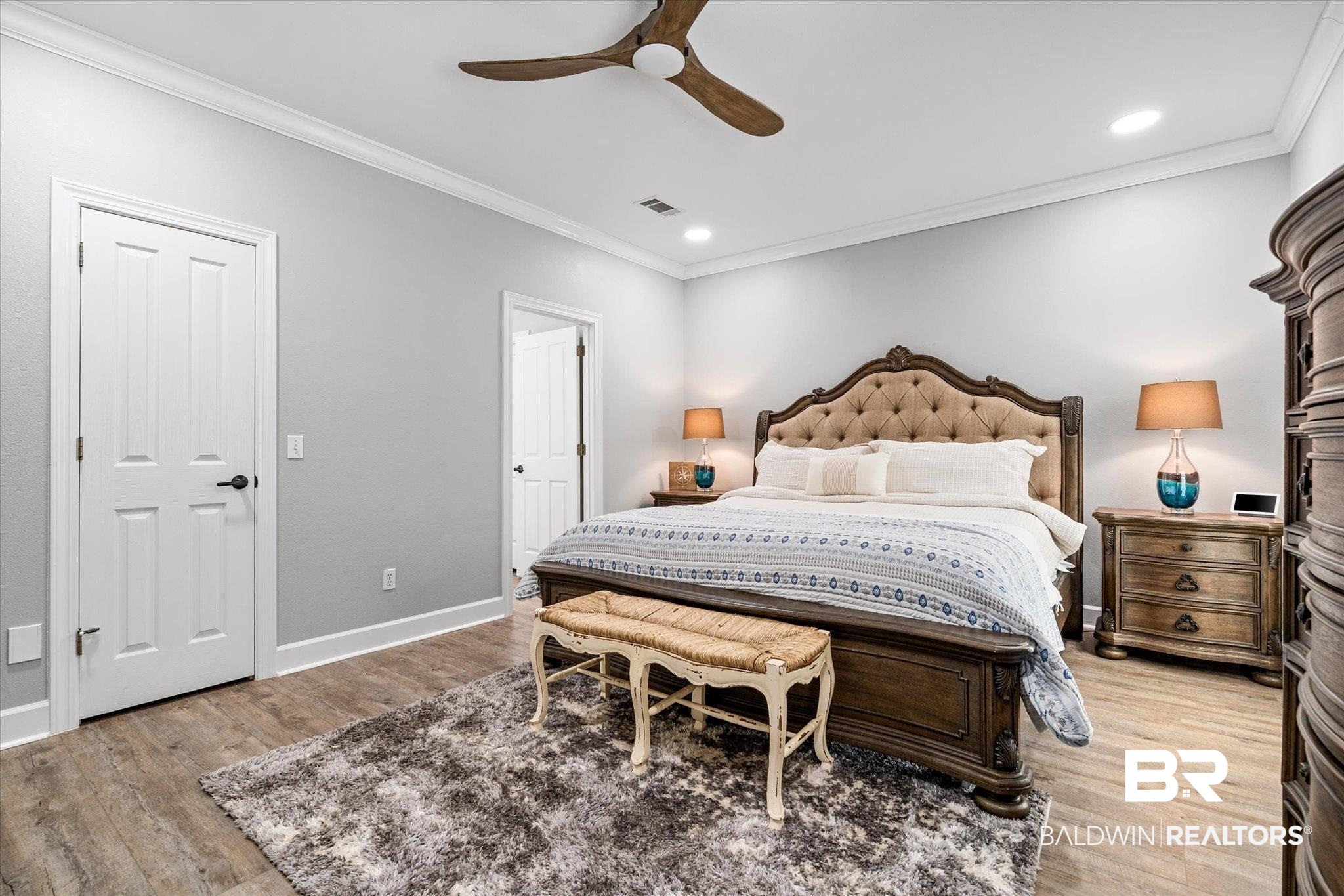 4947 Look Rook Road Orange Beach, AL 36561 - Photo 13 of 24 Bedroom with light wood finished floors, visible vents, baseboards, and crown molding