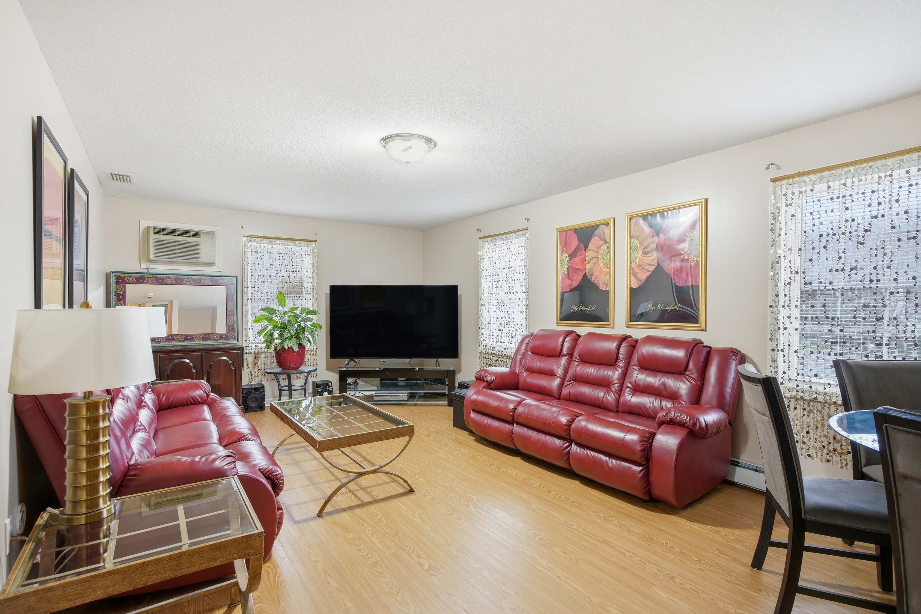 35 Fairfield Lane Bloomfield, CT 06002 - Photo 15 of 40 a living room with furniture a flat screen tv and a refrigerator