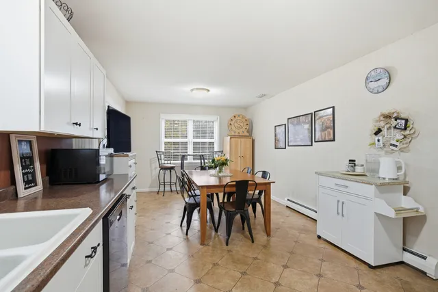 a view of a dining room with furniture and a kitchen