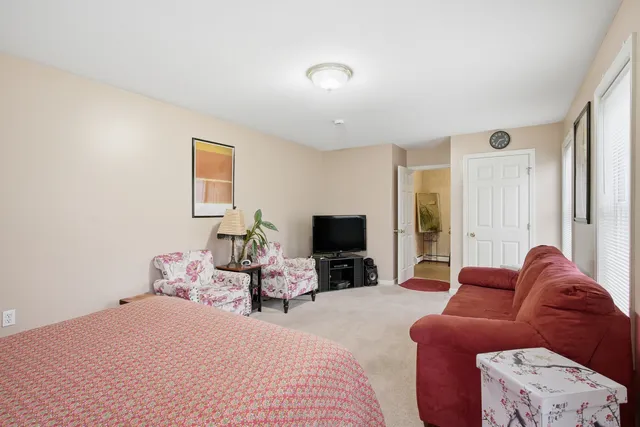 a bedroom with furniture or couch and a flat screen tv