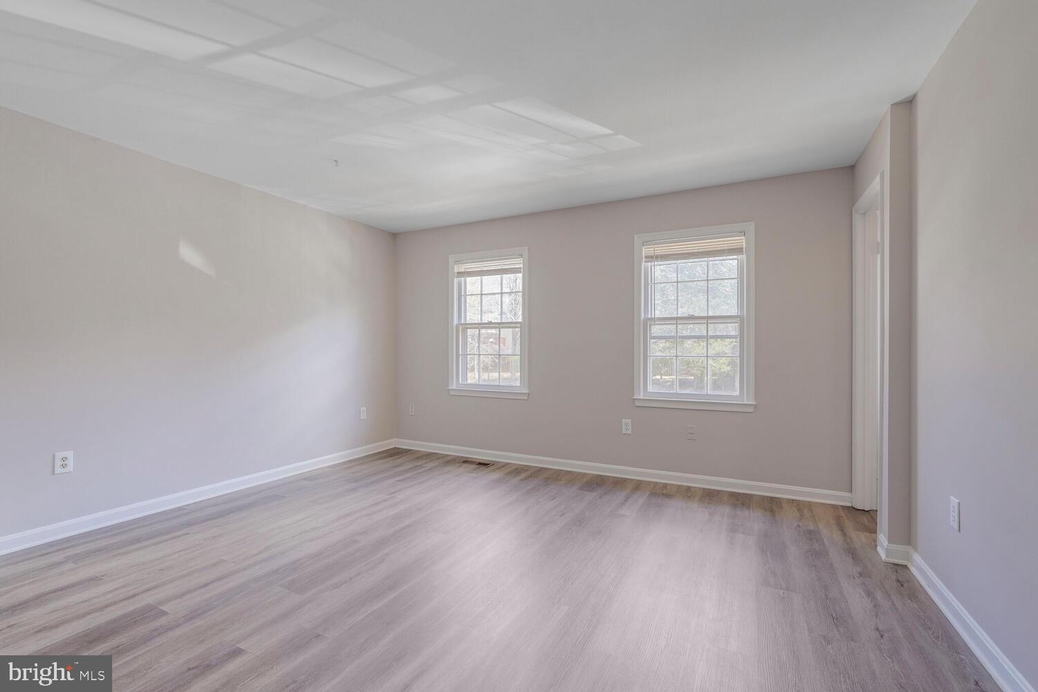 7314 Eggar Woods Lane Springfield, VA 22153 - Photo 11 of 23 an empty room with wooden floor and windows