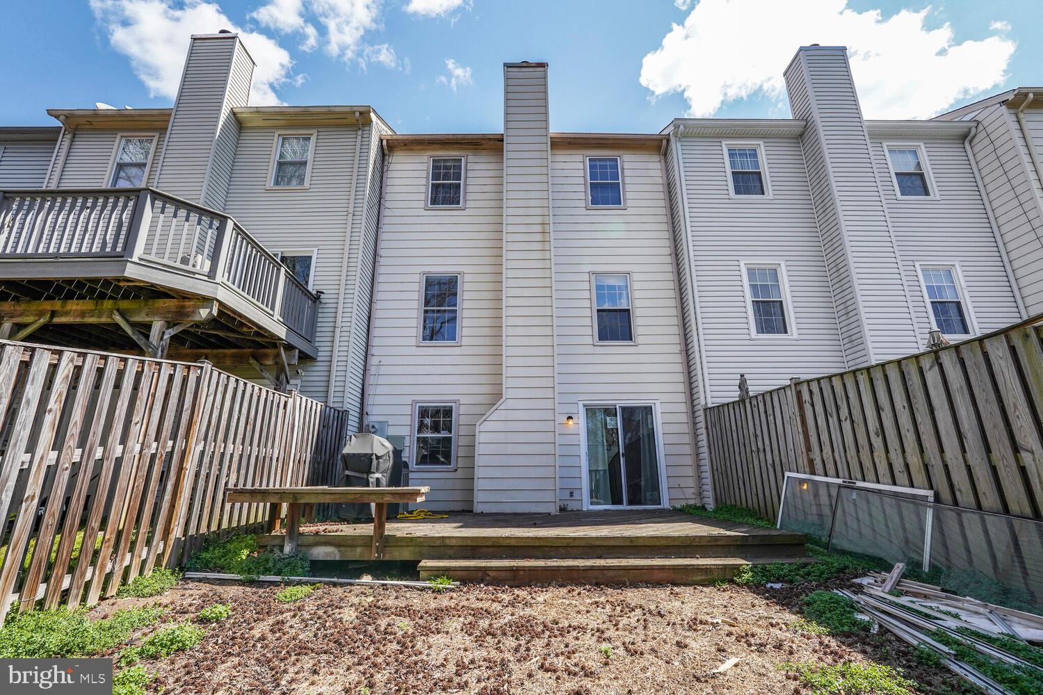 7314 Eggar Woods Lane Springfield, VA 22153 - Photo 20 of 23 a view of a house with a small yard and wooden floor and fence