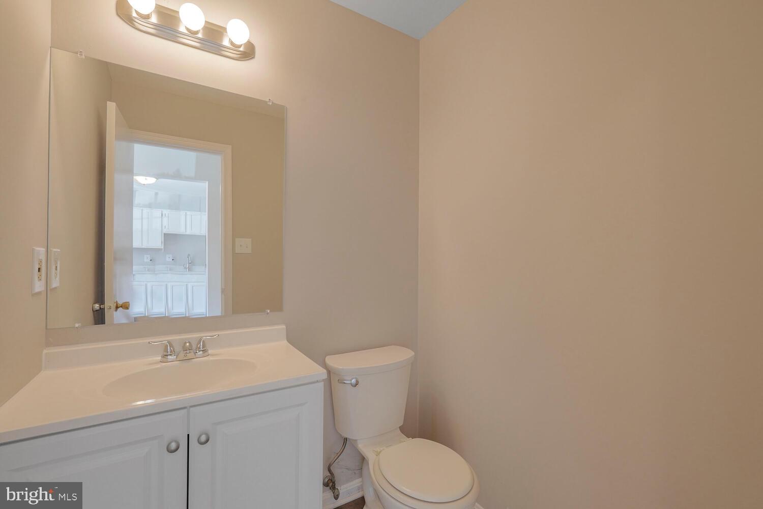 7314 Eggar Woods Lane Springfield, VA 22153 - Photo 5 of 23 a bathroom with a sink a toilet and mirror