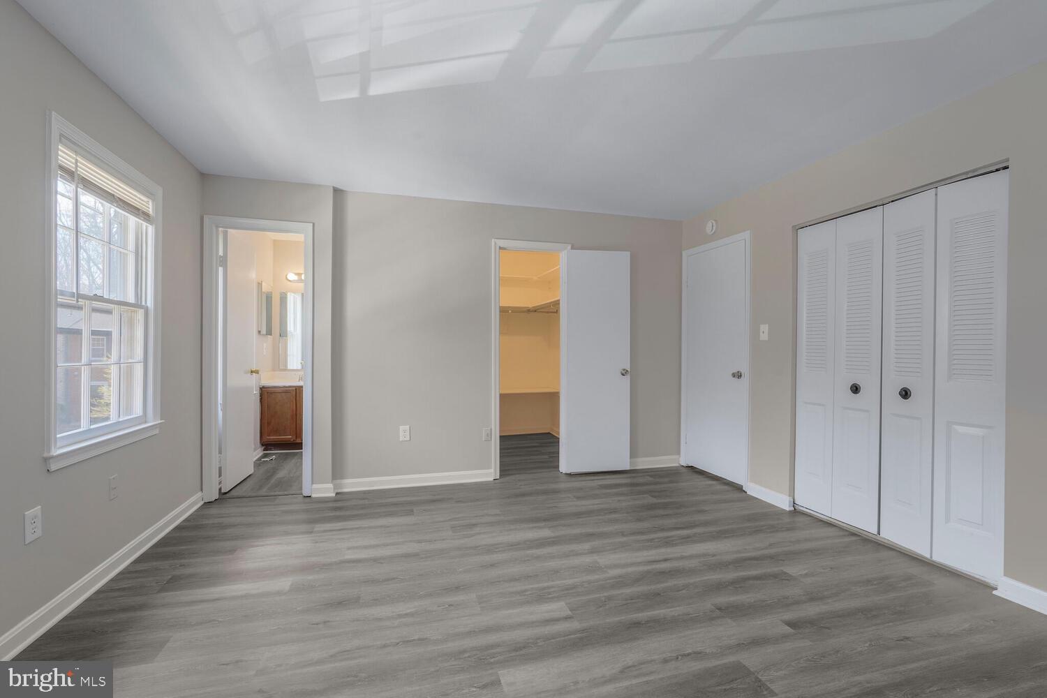 7314 Eggar Woods Lane Springfield, VA 22153 - Photo 10 of 23 a view of an empty room with wooden floor and window
