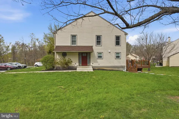 a view of a white house with a yard