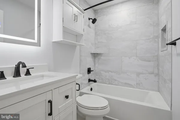 a bathroom with a sink a toilet and a bathtub