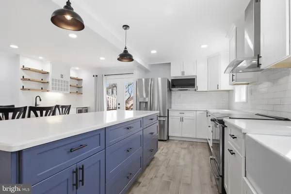 a kitchen with a sink stainless steel appliances and cabinets
