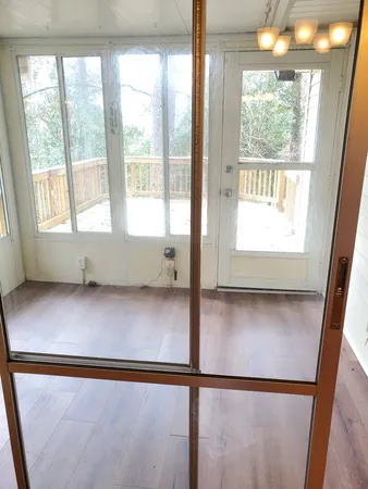 a view of an empty room with wooden floor