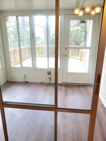 a view of an empty room with wooden floor