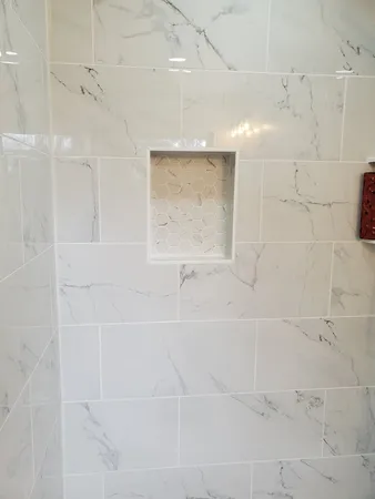 a white toilet sitting next to a bath tub and a shower