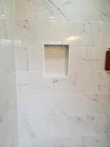 a white toilet sitting next to a bath tub and a shower