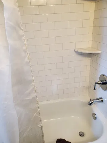 a bathroom with a sink toilet and window