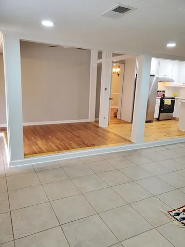 a view of a wall with rack and wooden floor