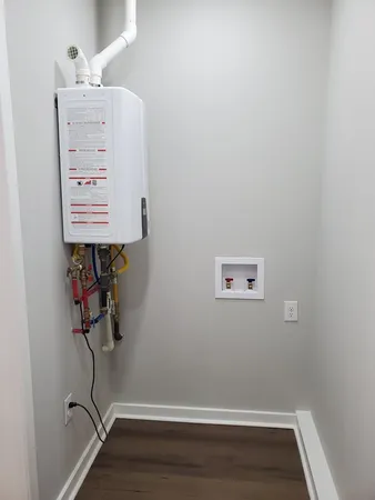 a kitchen with stainless steel appliances granite countertop a stove a sink and a white cabinets