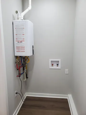 a kitchen with stainless steel appliances granite countertop a stove a sink and a white cabinets