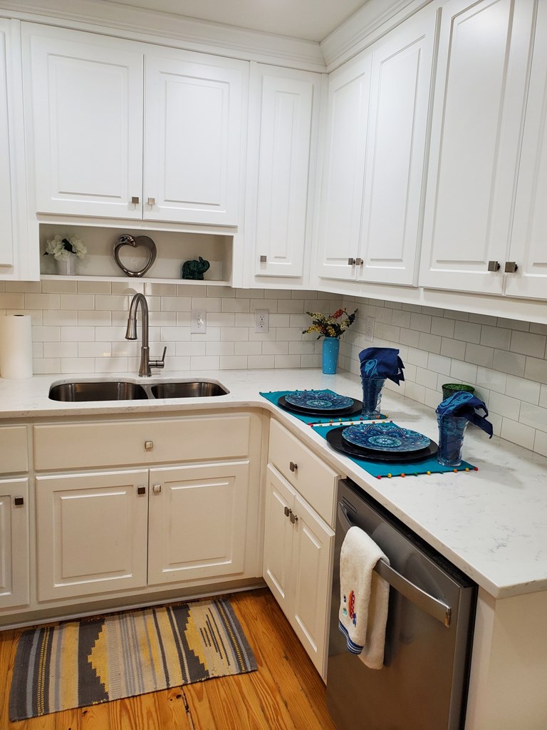 6311 Gable Avenue Columbus, GA 31909 - Photo 6 of 27 a kitchen with stainless steel appliances granite countertop a sink stove and cabinets