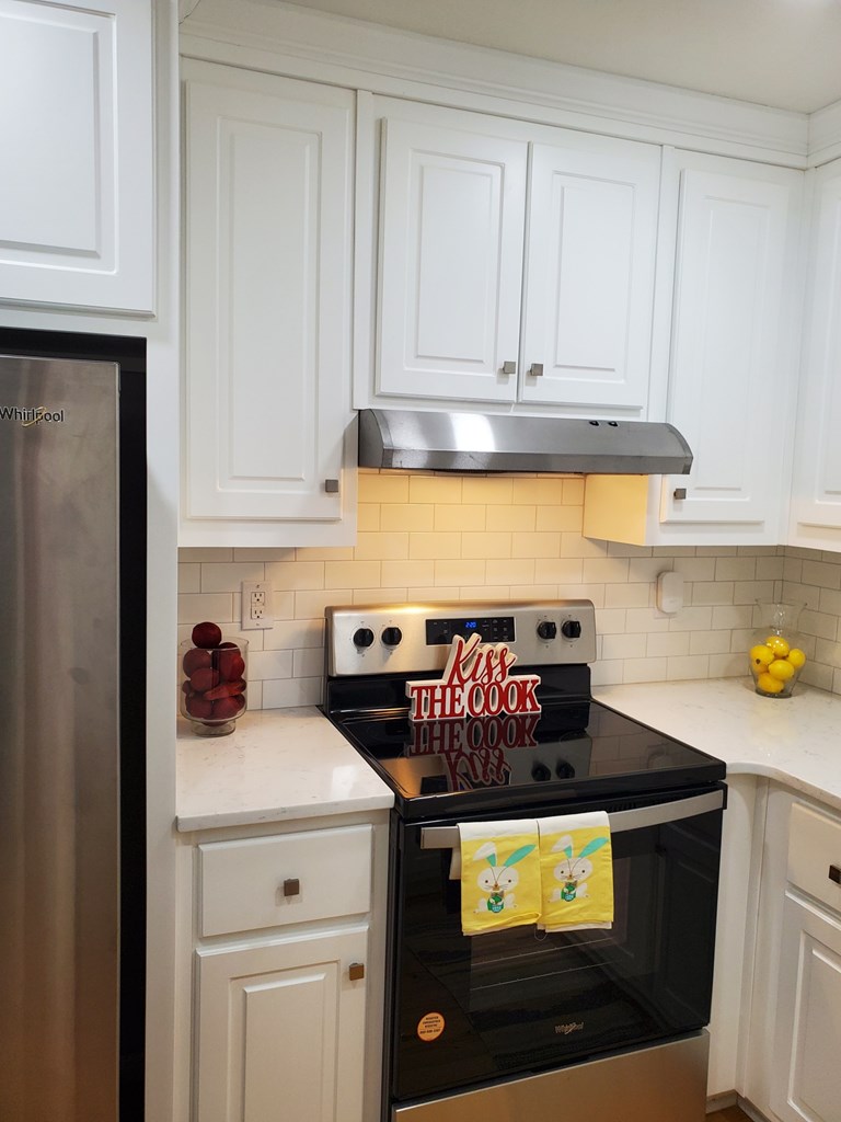 6311 Gable Avenue Columbus, GA 31909 - Photo 7 of 27 a kitchen with stainless steel appliances granite countertop a stove a microwave and cabinets