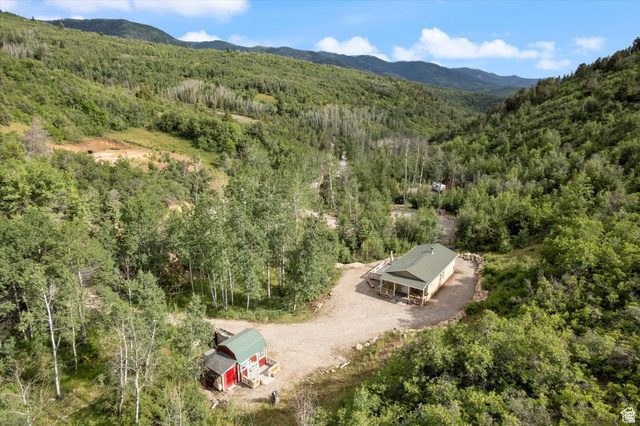 19845 North 14070 (north Fork Rd) Road East, Unit 313 Mount Pleasant, UT 84647 - Photo 28 of 39 Aerial view of property and surrounding area featuring a forest and a mountain backdrop.