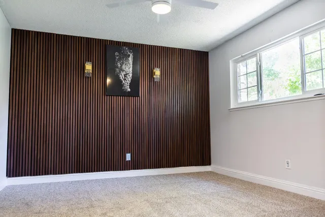 an empty room with windows and cabinet
