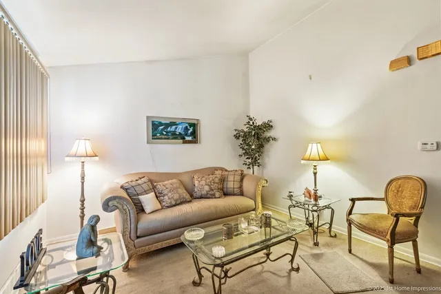 a living room with furniture and a lamp