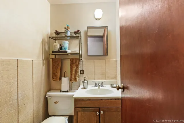a bathroom with a sink a toilet and mirror
