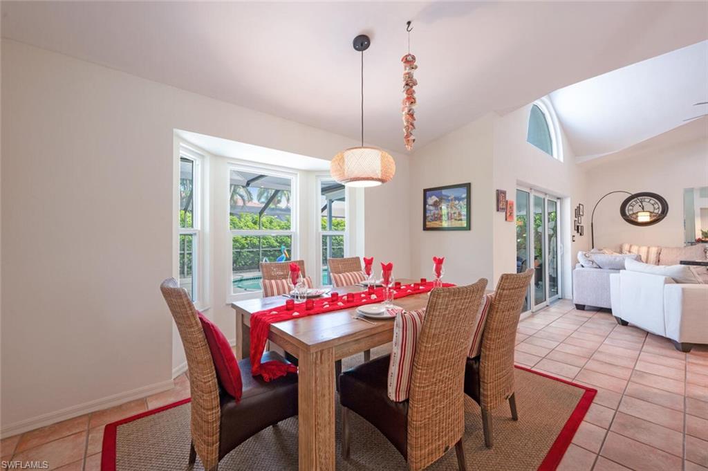 229 Countryside Drive Naples, FL 34104 - Photo 14 of 44 a view of a dining room with furniture window and wooden floor