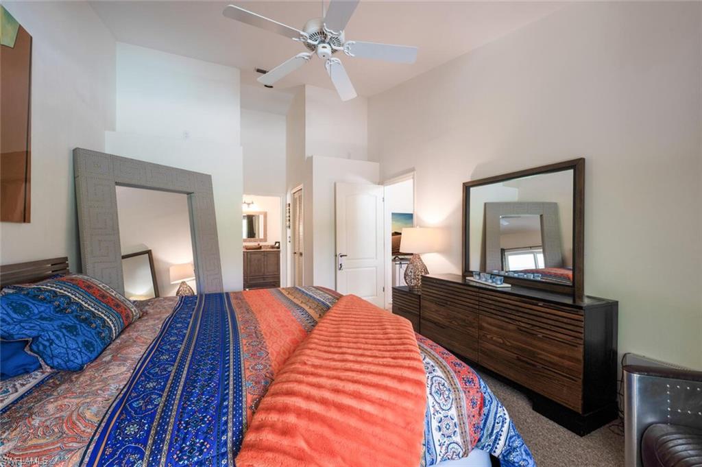 229 Countryside Drive Naples, FL 34104 - Photo 17 of 44 a bedroom with bed and wooden floor