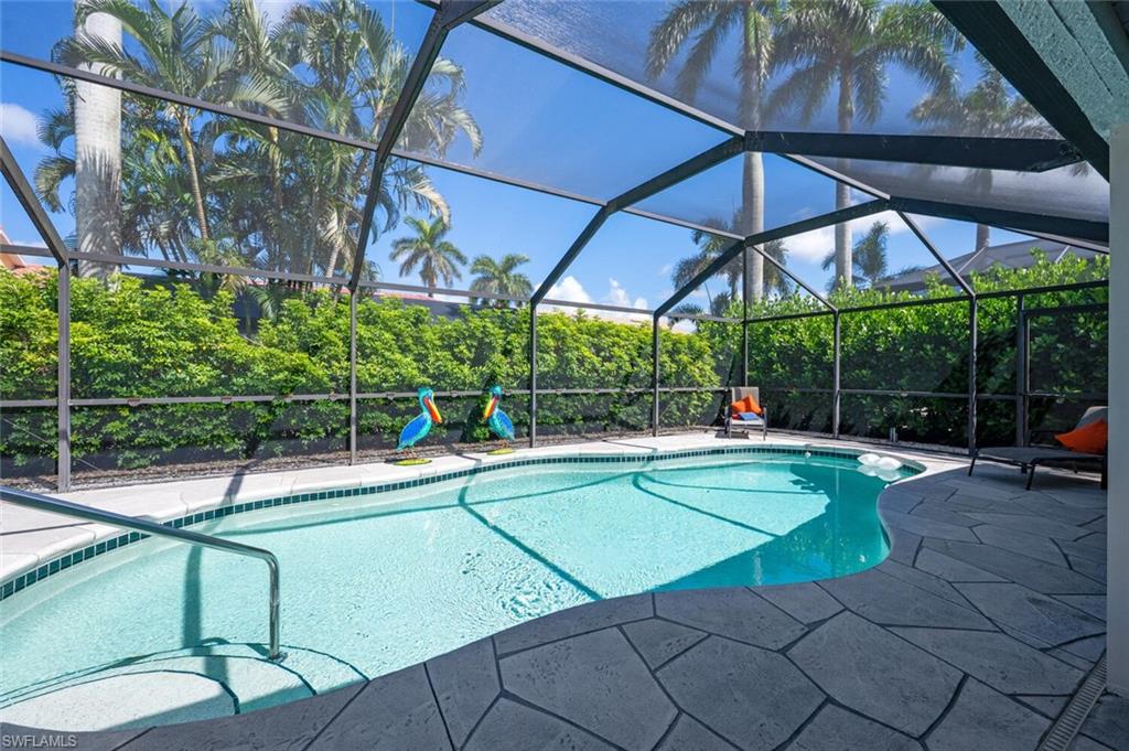229 Countryside Drive Naples, FL 34104 - Photo 24 of 44 a view of a swimming pool with a patio and a yard