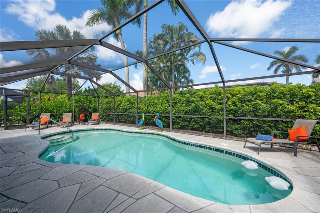 229 Countryside Drive Naples, FL 34104 - Photo 25 of 44 a view of a swimming pool with a patio and plants