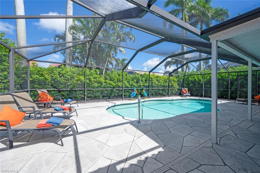 229 Countryside Drive Naples, FL 34104 - Photo 29 of 44 a view of yard with a table and chairs under an umbrella