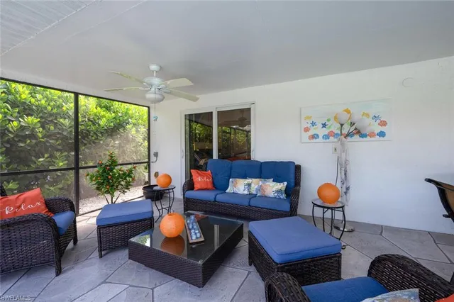 a living room with furniture a rug and a large window