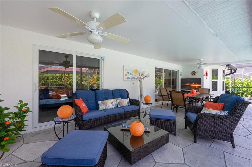 229 Countryside Drive Naples, FL 34104 - Photo 32 of 44 a living room with furniture a rug and a large window