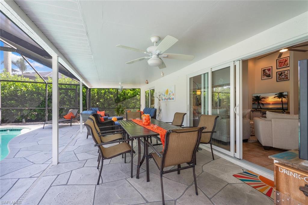 229 Countryside Drive Naples, FL 34104 - Photo 33 of 44 a dining room with furniture a chandelier and fireplace