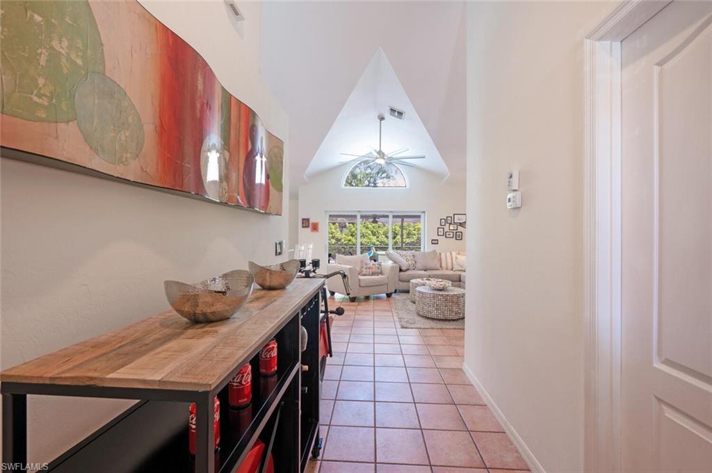 229 Countryside Drive Naples, FL 34104 - Photo 5 of 44 a kitchen with a cabinets a stove and a window