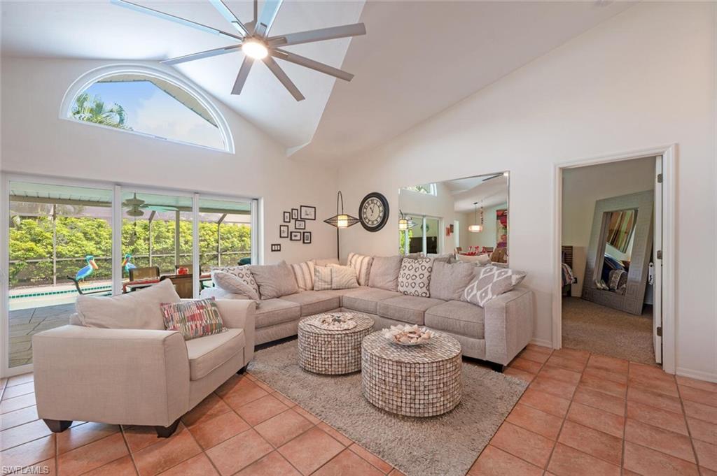 229 Countryside Drive Naples, FL 34104 - Photo 6 of 44 a living room with furniture and a large window