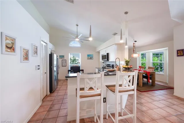 a kitchen with stainless steel appliances a refrigerator sink and cabinets