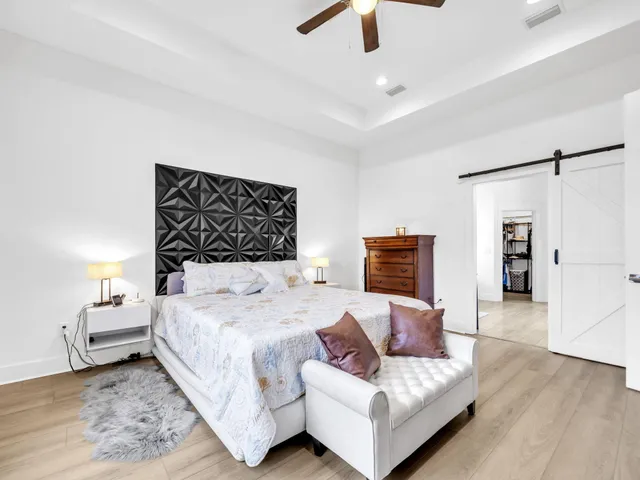 a bedroom with a bed and ceiling fan
