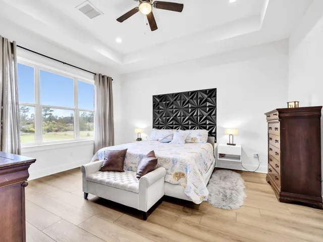 a bedroom with a bed furniture and a large window
