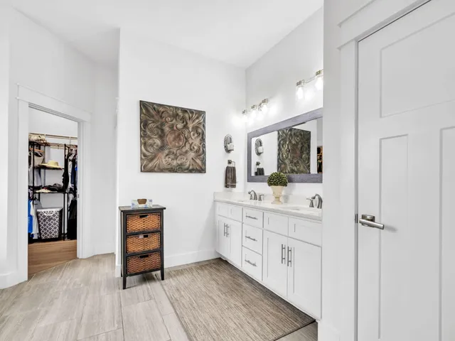 a room with two chair and painting on the wall