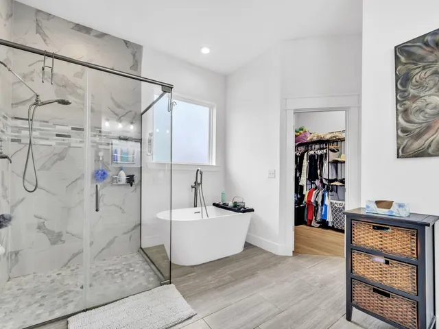 a spacious bathroom with a tub and a shower