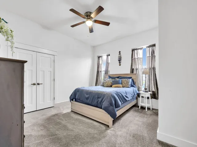 a spacious bedroom with a bed and a chandelier
