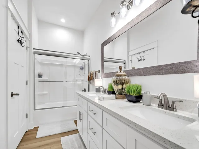 a bathroom with a double vanity sink and a mirror