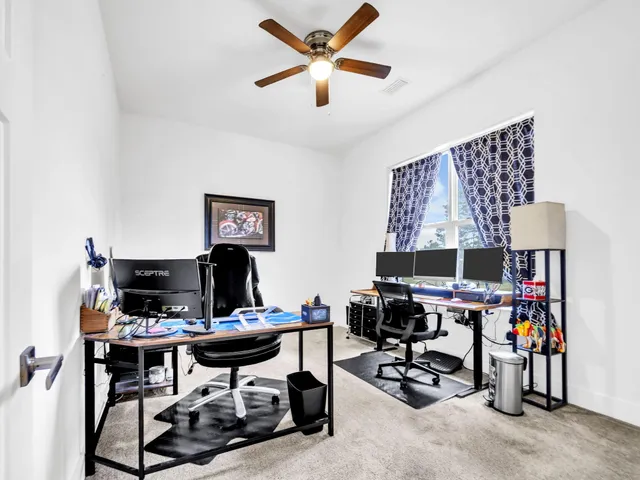 a view of a workspace with furniture