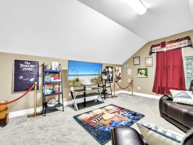 a living room with furniture and a book shelf