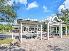 a view of a house with backyard porch and sitting area